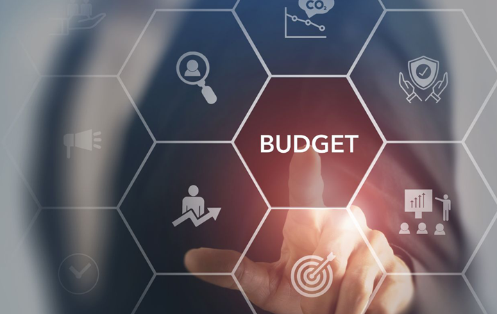 finger touching budget on board