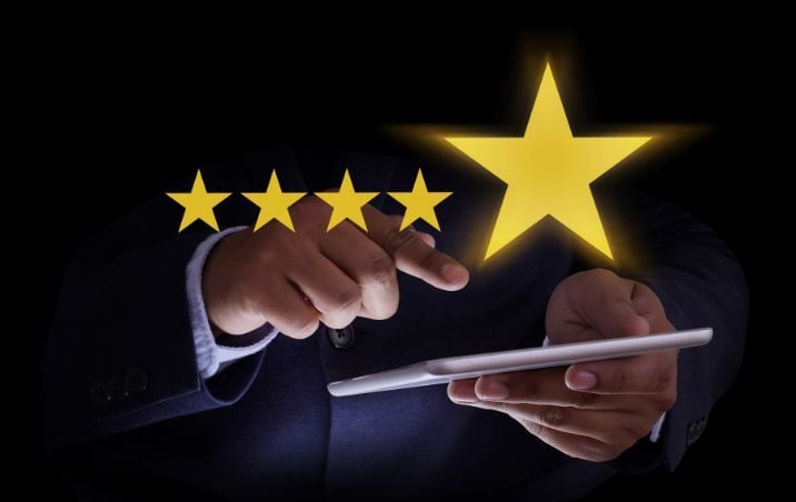 man with mobile device and five stars